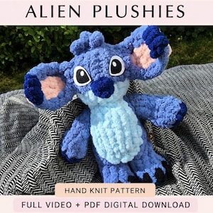 May include: A blue plush toy with large ears, a light blue belly, and black and white eyes. The text ALIEN PLUSHIES, HAND KNIT PATTERN, and FULL VIDEO + PDF DIGITAL DOWNLOAD are visible. The toy has a textured, fuzzy appearance and dark blue accents.
