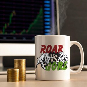 May include: White ceramic mug with the words "ROAR VS GORE" and illustrations of a bull and a bear. The mug is next to stacks of gold coins, with a computer monitor displaying a stock chart in the background.