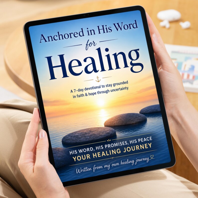 May include: A digital tablet displaying a devotional book cover titled Anchored in His Word for Healing. The cover features a sunset over calm water with smooth stones, an anchor icon, and the subtitle A 7-day devotional to stay grounded.