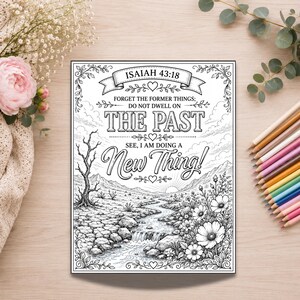 Op de afbeelding: Een zwart-wit kleurplaat met een landschap van een beek, bergen en bloemen. De tekst luidt: Isaiah 43:18, Forget the former things; do not dwell on the past. See, I am doing a new thing! Het ontwerp bevat decoratieve randen en versieringen.