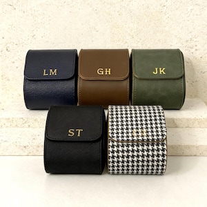 May include: A set of three ceramic mugs with a speckled, matte finish. The mugs are in shades of cream, light gray, and dark gray. Each mug has a simple, minimalist design and a rounded handle.