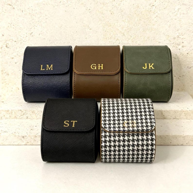 May include: A set of three ceramic mugs with a speckled, matte finish. The mugs are in shades of cream, light gray, and dark gray. Each mug has a simple, minimalist design and a rounded handle.