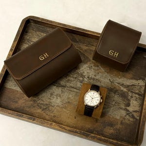 May include: A set of three ceramic mugs with a speckled, matte finish. The mugs are in shades of cream, light gray, and dark gray. Each mug has a simple, minimalist design, perfect for coffee or tea.