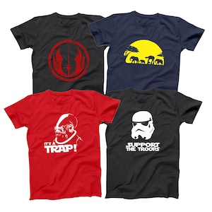 May include: Four graphic t-shirts. A black tee with a red emblem, a navy blue tee with a yellow sun and elephant silhouettes, a red tee with a white alien and the text "IT'S A TRAP!", and a black tee with a white Stormtrooper and "SUPPORT THE TROOPS".