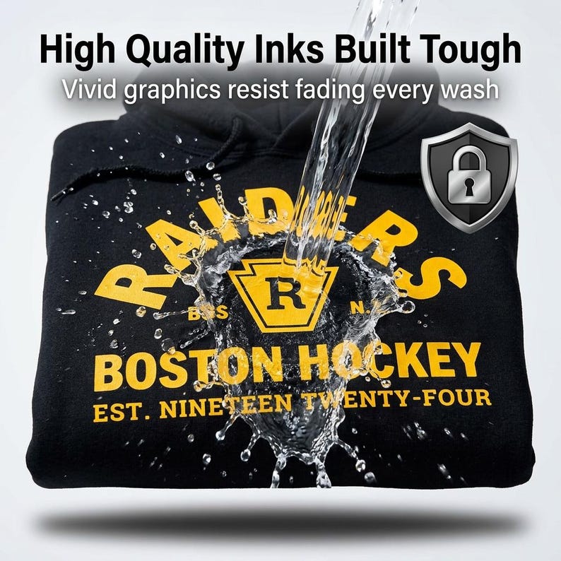 May include: A black hooded sweatshirt featuring yellow text that reads RAIDERS BOSTON HOCKEY EST. NINETEEN TWENTY-FOUR with a central R logo. Water splashes over the graphic, accompanied by the text High Quality Inks Built Tough and a shield icon.