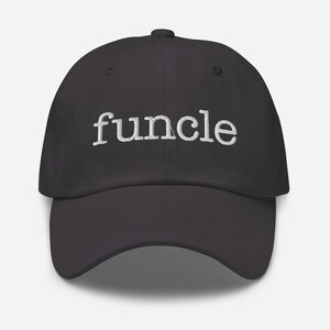 May include: A black baseball cap with the word "funcle" embroidered in white. The cap has a curved brim and an adjustable strap at the back. The hat is a casual accessory.