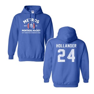 May include: A royal blue hooded sweatshirt featuring a front graphic with the text METROS, QU&Eacute;, CA, MONTR&Eacute;AL HOCKEY, EST NINETEEN HUNDRED-NINE and a logo. The back displays the name HOLLANDER and the number 24 in a white, textured, dotted font.