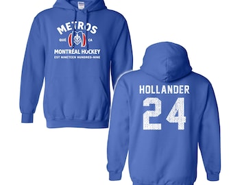 May include: Royal blue hoodie with the text "METROS" and "MONTREAL HOCKEY" in white. The back of the hoodie displays the name "HOLLANDER" and the number "24" in white. The hoodie has a front pocket and a hood.
