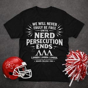May include: Black t-shirt with white text: "WE WILL NEVER TRULY BE FREE UNTIL NERD PERSECUTION ENDS." Below the text is "ΛΛΛ LAMBDA LAMBDA LAMBDA * ADAMS COLLEGE 1984 *". A red football helmet and a red and white pom-pom are also in the image.