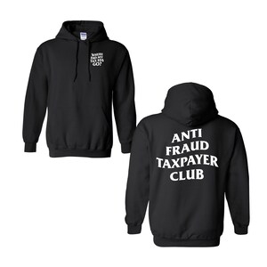 May include: A black hooded sweatshirt featuring white text on the front left chest that reads WHERE DID MY TAX $$$ GO? The back of the hoodie displays the white text ANTI FRAUD TAXPAYER CLUB in a curved layout. The garment has long sleeves and a hood.
