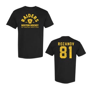 May include: Black t-shirt with gold lettering. The front reads "RAIDERS BOSTON HOCKEY EST. NINETEEN TWENTY-FOUR." The back displays "ROZANOV 81" in gold. A classic design for hockey fans.