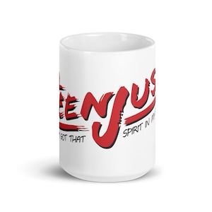 May include: White ceramic mug with the red text "ENJOY US" in a stylized font. The mug also has the phrases "I GOT THAT" and "SPIRIT IN ME" in black text. The mug is a standard size for coffee or tea.
