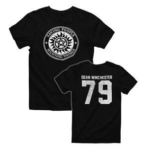 May include: Black t-shirts with white graphics. One shirt features a circular design with the text "Saving People, Hunting Things." The other shirt displays "Dean Winchester" and the number "79."