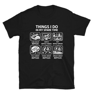 May include: A black short-sleeved t-shirt featuring a white graphic with the text THINGS I DO IN MY SPARE TIME. The design includes six square icons depicting activities related to reptiles, each with a corresponding caption below the icon.