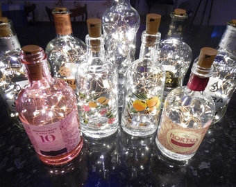 Upcycled Jura Whisky, Highland Park (Orkney), Big Peat, Wolfie's (Rod Stewart) + Scottish Six Isles Bottles with Fairy Lights