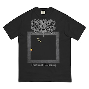May include: Black t-shirt with a graphic design. The design features an ornate, stylized emblem at the top, a dark square with a small image, and the words "Nocturnal Poisoning" at the bottom. The shirt is made of a soft material.