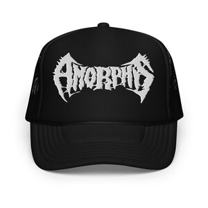 May include: Black trucker hat with the word "AMORPHIS" in white, stylized, gothic lettering across the front. The hat has a mesh back and a curved brim. The hat is a classic, casual accessory.