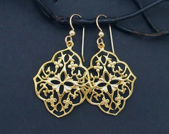 May include: A pair of gold-tone filigree earrings with a square design. The earrings have a delicate, intricate pattern and are perfect for adding a touch of elegance to any outfit.