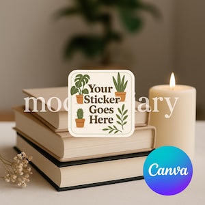 May include: A stack of books with a sticker that says "Your Sticker Goes Here" with plant illustrations. A lit candle and a Canva logo are also in the image. The books have beige pages and dark green spines.