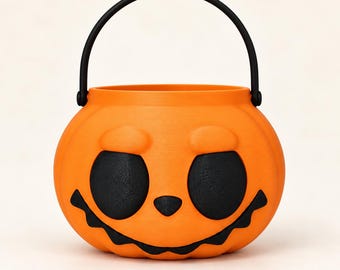 May include: A bright orange pumpkin-shaped bucket with a black handle. The bucket features a molded face with large, round black eyes, a small triangular nose, and a wide, jagged black mouth. The surface has a visible 3D printed texture.