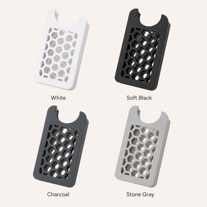 May include: Four cardholders in white, soft black, charcoal, and stone gray. Each has a rectangular shape with a honeycomb pattern and a curved top. The colors are labeled below each cardholder.