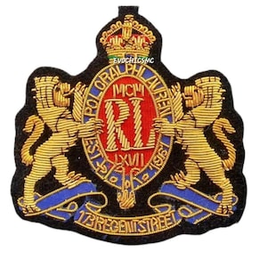 Può includere: Una toppa ricamata nera con una corona dorata sopra uno stemma ovale rosso con le lettere RL e i numeri romani MCMLXVII. Due leoni dorati fiancheggiano lo stemma, circondato dal testo POLO RALPH LAUREN e 173 REGENT STREET.