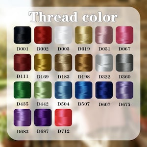 May include: A color chart displaying a variety of thread colors. The chart includes a range of hues, from black and red to gold, blue, and purple. Each color is labeled with a corresponding code, such as D001, D002, and D003, under the title "Thread color."