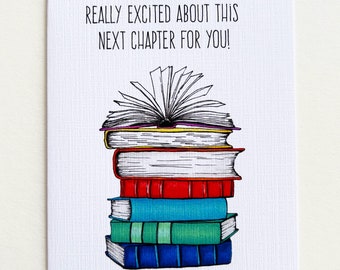 May include: A white greeting card with the text "REALLY EXCITED ABOUT THIS NEXT CHAPTER FOR YOU!". The card features a stack of colorful books, with one open at the top. The books are red, teal, green, and blue.