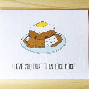 May include: A white card with a hand-drawn illustration of a plate of Loco Moco, a Hawaiian dish of rice, ground beef, gravy, and a fried egg. The text "I love you more than Loco Moco!" is printed below the illustration.