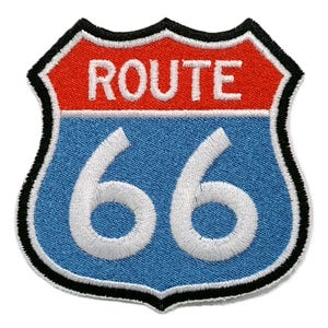 May include: Embroidered Route 66 patch in the shape of a shield. The top section is red with the word "ROUTE" in white. The bottom section is blue with the white number "66". The patch is outlined in black and white.