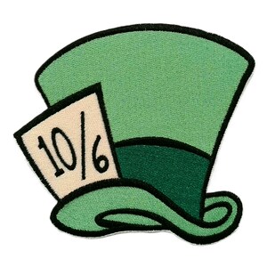 May include: Embroidered patch featuring the Mad Hatter's hat from Alice in Wonderland. The hat is primarily light green with a darker green band and black trim. A small cream-colored tag displays the number "10/6".