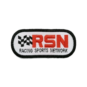 May include: An oval-shaped embroidered patch with a white background and a thick black border. It features a black and white checkered flag icon, the bold red letters RSN, and the black text RACING SPORTS NETWORK printed underneath.