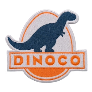 May include: Embroidered patch featuring a blue dinosaur silhouette on a white background, framed by an orange outline. The word "DINOCO" is displayed in orange block letters below the dinosaur image. The patch has a white border.
