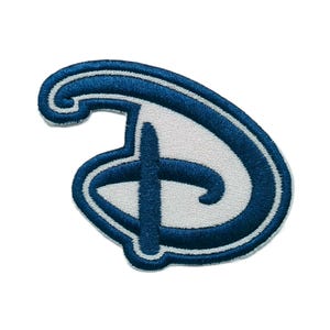 May include: An embroidered patch featuring a stylized letter D in a cursive script. The design consists of a thick, dark blue border outlining a white interior, with a vertical dark blue line crossing through the center of the letter shape.