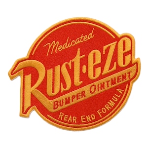 May include: Embroidered patch in a circular shape with a red background and gold lettering. The text reads "Medicated RUST-EZE BUMPER OINTMENT REAR END FORMULA". The patch has a yellow border.