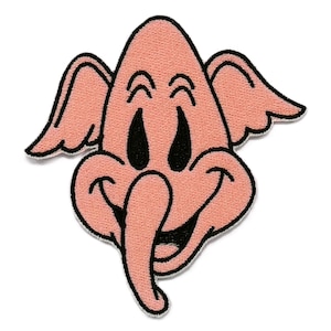 May include: A pink patch featuring a cartoon elephant with large ears, a long trunk, and a smiling face. The elephant has black eyes and a black outline. The patch is likely for clothing or accessories.