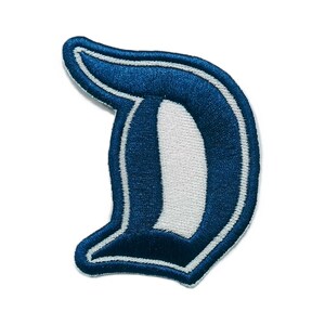 May include: An embroidered patch in the shape of the letter D, featuring a dark blue gothic-style font with a white inner border and a dark blue outer border, finished with a thick white stitched edge on a plain white background.