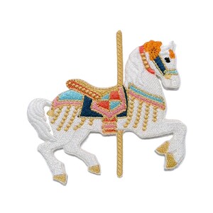 May include: An embroidered patch of a white carousel horse with a gold pole. The horse features an orange mane, a blue and pink saddle with gold fringe, and gold hooves. The design is rendered in detailed thread work with vibrant colors.