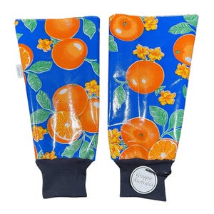 May include: A pair of blue and orange arm warmers with a pattern of oranges and leaves. The arm warmers have a navy blue cuff and a white label that says "Graggie Australia".