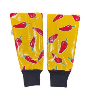 May include: A pair of yellow arm warmers with a red chili pepper pattern. The arm warmers have black elastic cuffs.