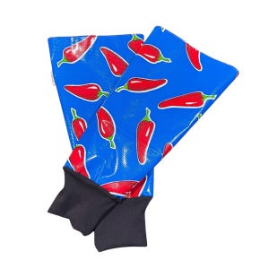 May include: A pair of blue and red knee warmers with a chili pepper pattern. The warmers have black cuffs.