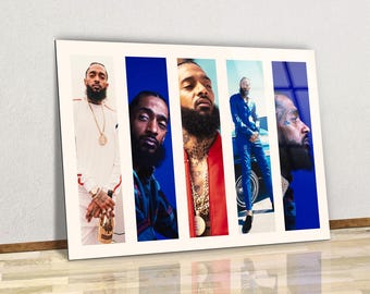 May include: A framed print featuring five vertical panels with images of a man. The panels alternate between images of the man against a blue background and images against a white background. The man is wearing various outfits and jewelry.