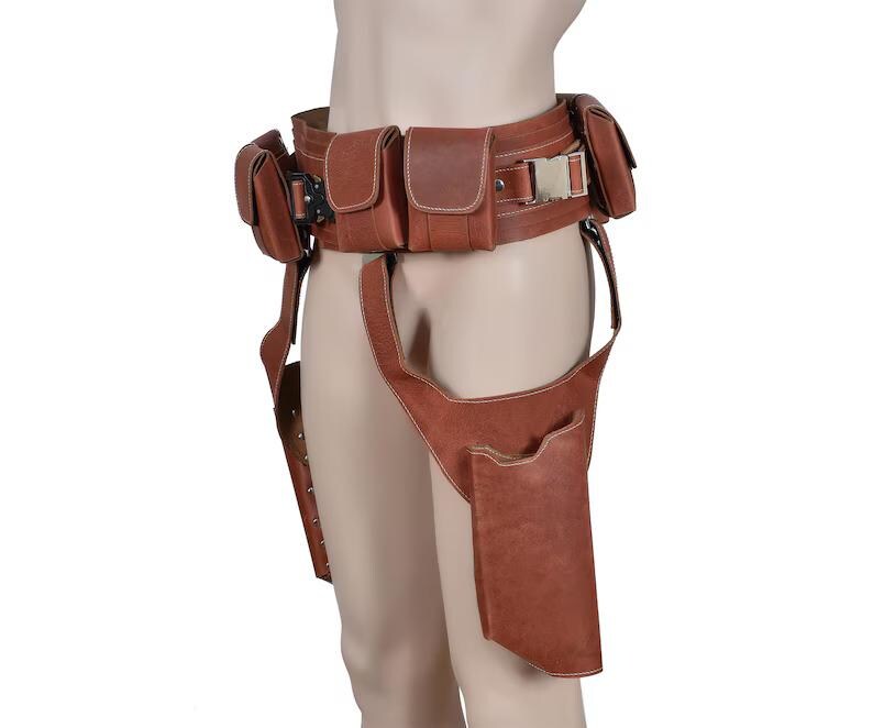 May include: Brown leather utility belt with multiple pouches and a silver buckle. The belt includes a thigh holster and additional pouches for carrying items. The leather has a slightly distressed appearance.