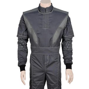 May include: A gray racing suit with white stitching and geometric patterns on the sleeves. The suit has a high collar, a belt, and black cuffs. The suit is displayed on a mannequin.