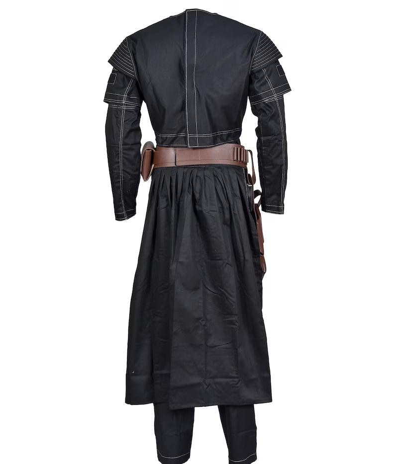 May include: Black costume with white stitching. The outfit features a long-sleeved jacket, a long skirt, and matching trousers. A brown belt and holster are also included. The costume is designed with a unique, layered construction.
