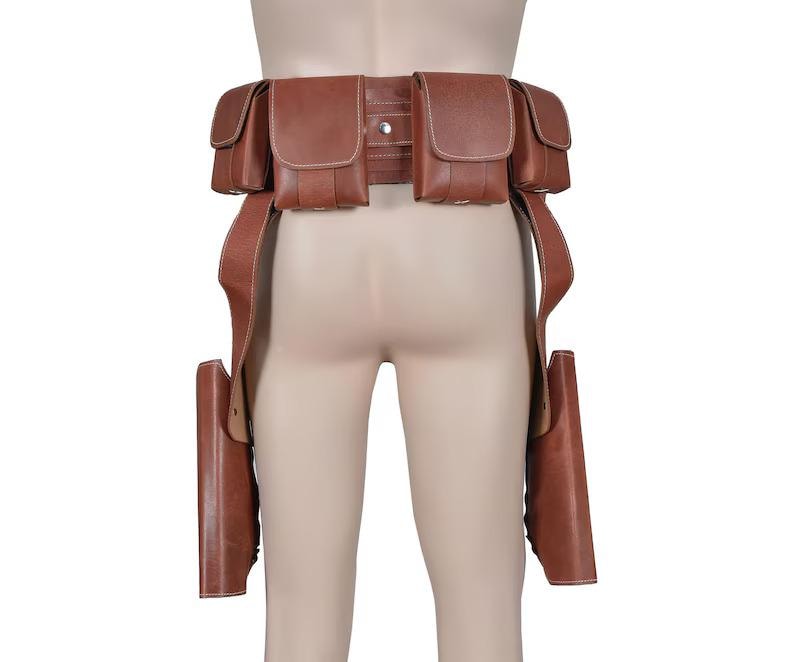 May include: Brown leather utility belt with multiple pouches and two holster-style leg straps. The belt features a series of rectangular pouches and is designed to be worn around the waist. The leather appears to be a medium brown color.