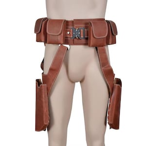 May include: Brown leather utility belt with multiple pouches and a buckle closure. The belt has suspenders that attach to two additional pouches. The belt is designed to be worn around the waist and thighs.
