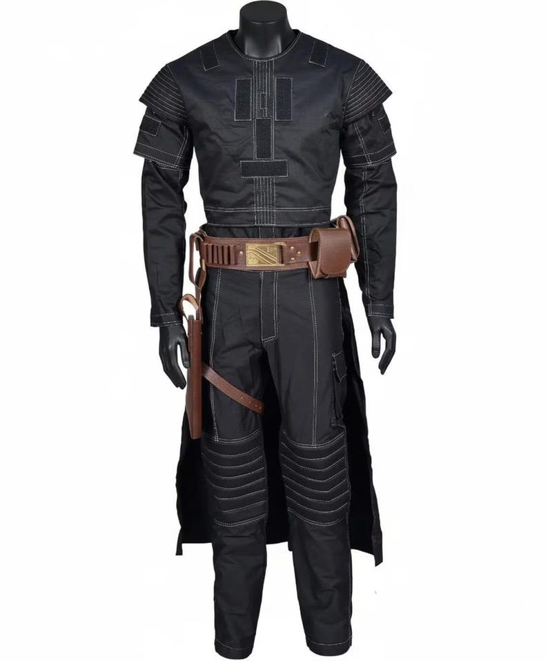 May include: Black costume featuring a long-sleeved top, trousers, and a belt with a gold buckle. The costume includes a brown holster and a pouch. White stitching details the outfit. The mannequin wears black gloves.