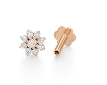 May include: A pair of rose gold earrings. One earring features a flower design with seven round, clear gemstones. The other earring has a post and a flower-shaped backing. The earrings are set against a white background.