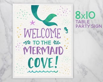 May include: Welcome to the Mermaid Cove! 8x10 table party sign with a mermaid tail, starfish, and seahorse in green, purple, and gold on a white background.